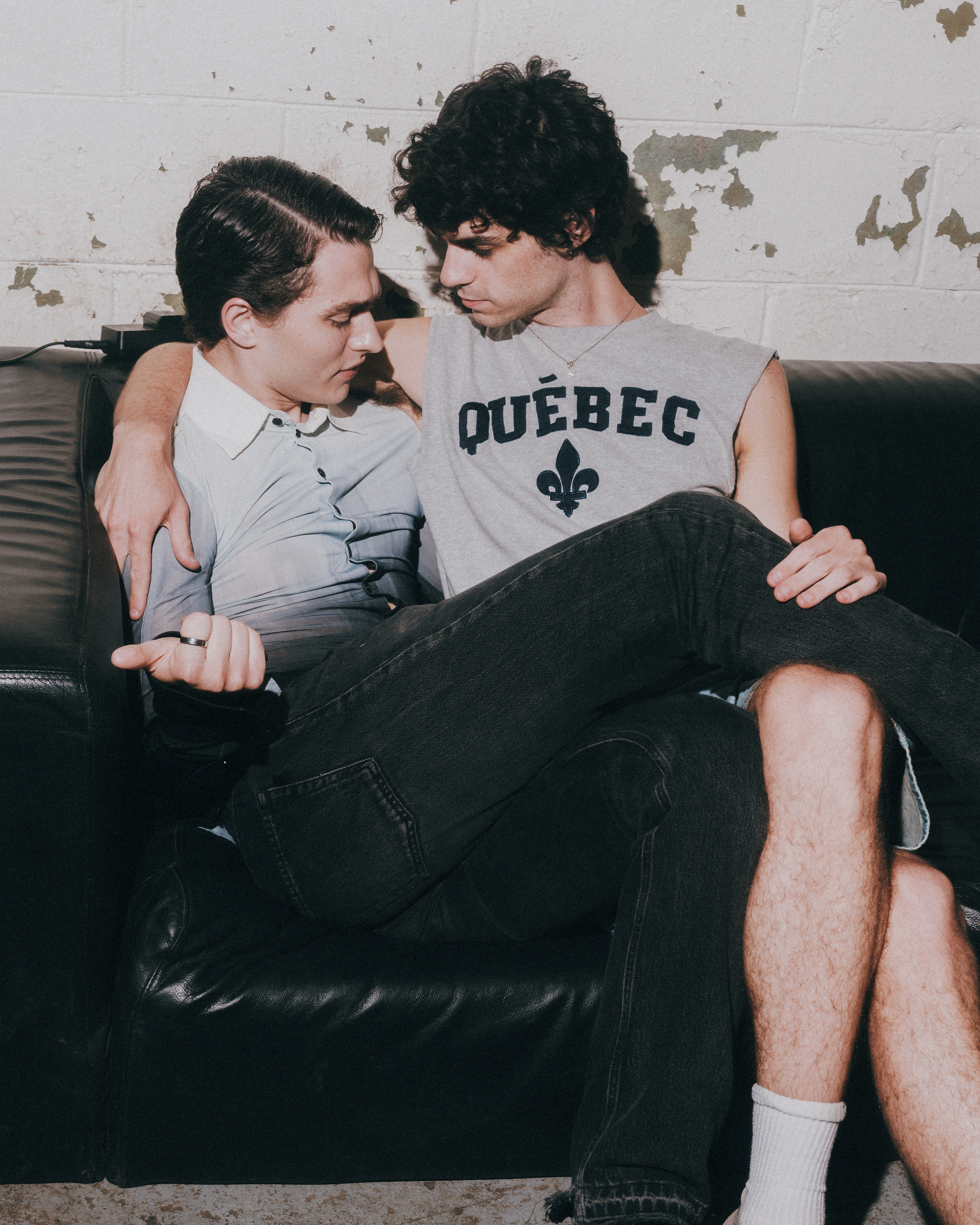Two Pep Rally guests sitting close together on a couch